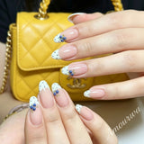 High-quality handmade almond press-on nails with white French tips, black polka dots, and realistic hand-painted blueberries on a natural nude base