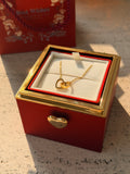 Red preserved rose jewelry gift box with a rotating golden hexagon clasp revealing a customized heart necklace inside.