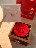 Red preserved rose jewelry gift box with a rotating golden heart clasp revealing a customized heart necklace inside.