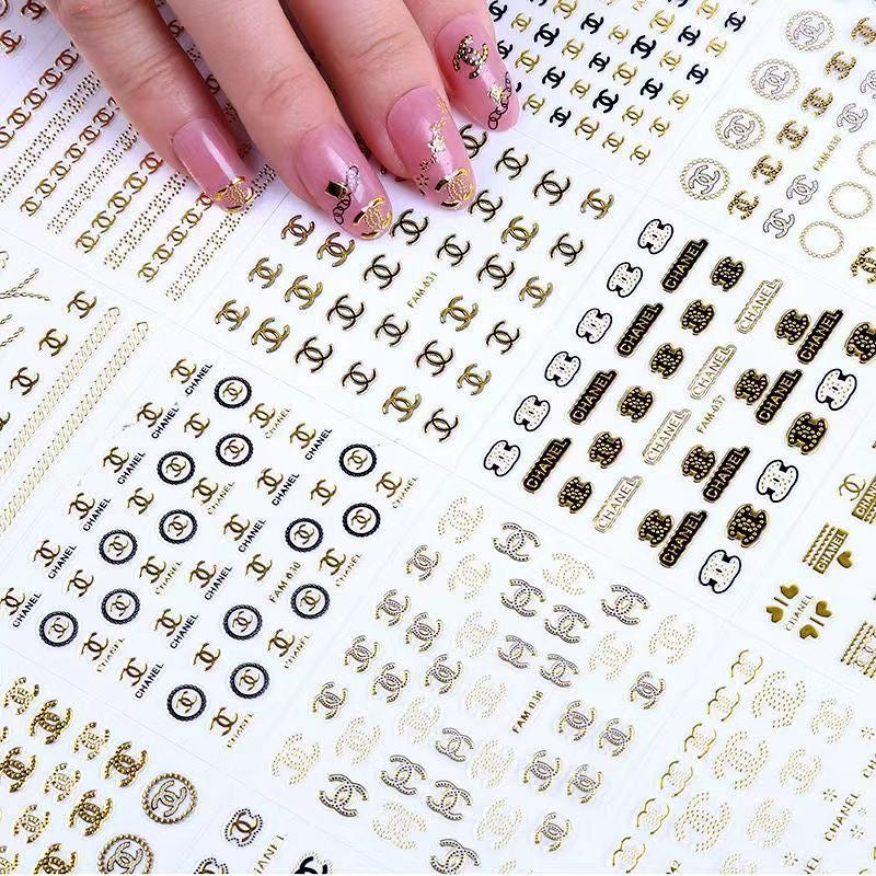 Luxury designer nail stickers featuring iconic brand logos and monogram patterns, 3D nail art decals.