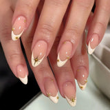 Vanilla cream French tip press-on nails with almond shape, featuring 3D gold studs and celestial gold star nail art on a nude base，Starry Night French Nails