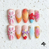Amourwa luxury handmade 3D flower and ribbon bow press-on nails display. Features gorgeous pastel pink and white gradient coffin nails decorated with intricate 3D embossed floral designs, purple bow tie charms, pearl embellishments, and textured summer coquette aesthetic nail art.
